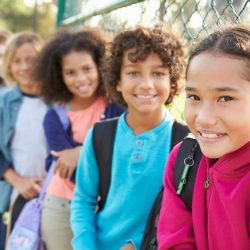 Aws Group Of Students Smiling While Leaning On A Gate