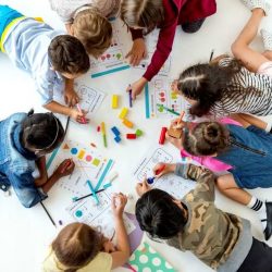 Overhead View Of Students Working On Math Sheets In A Circle