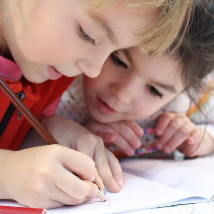 Two girls writing