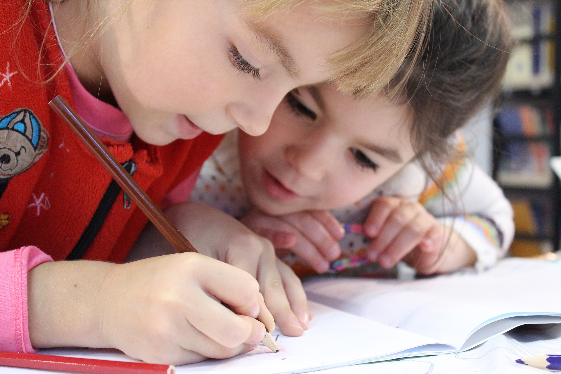 Two girls writing