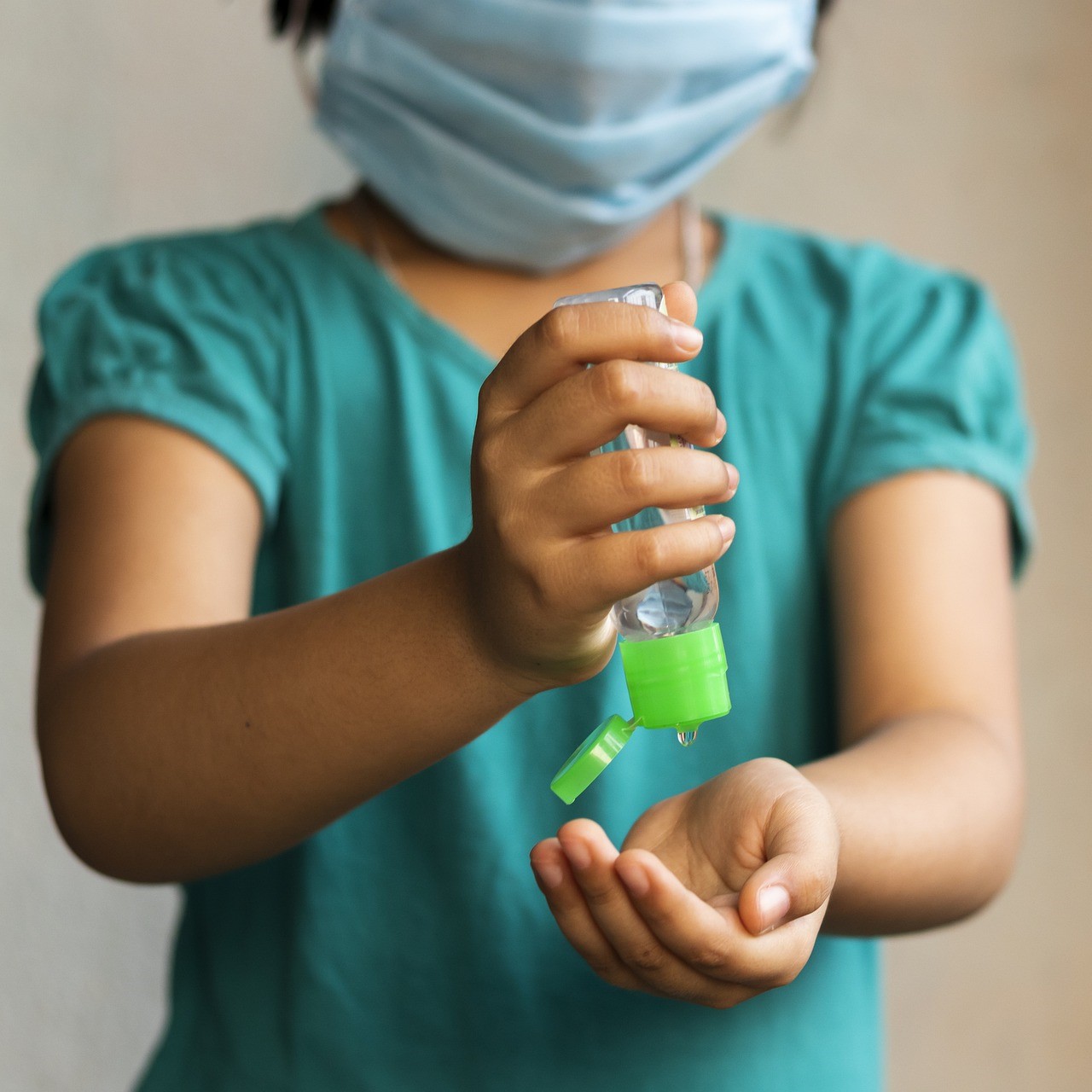 Girl using hand sanitizer