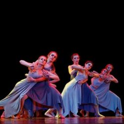 Girl Dancers In Blue Dresses Performing On Stage