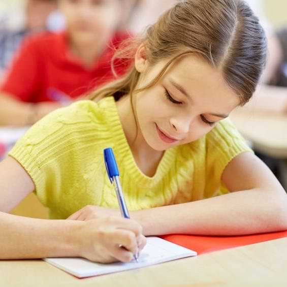 Girl In Yellow Shirt Writing In Notebook