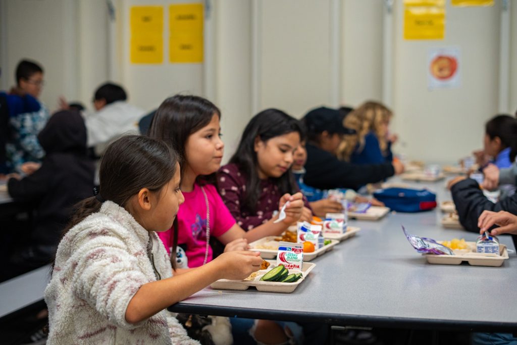 Kids eating lunch at school in cafeteria